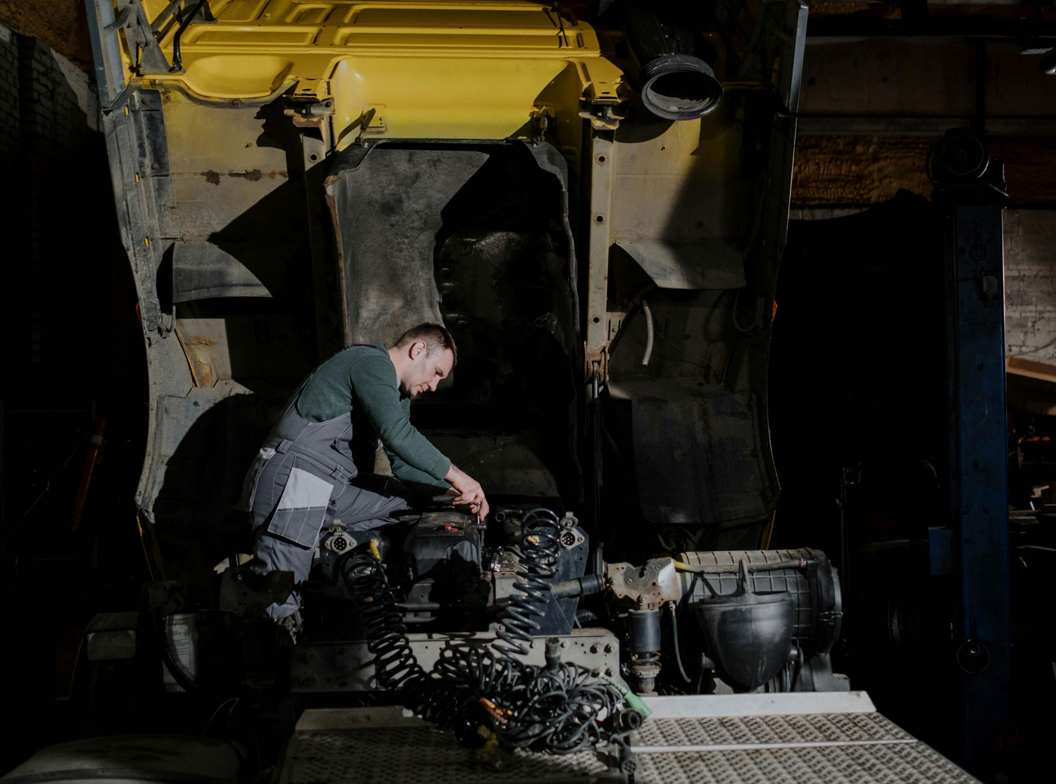 Technician running diagnostics on a commercial truck