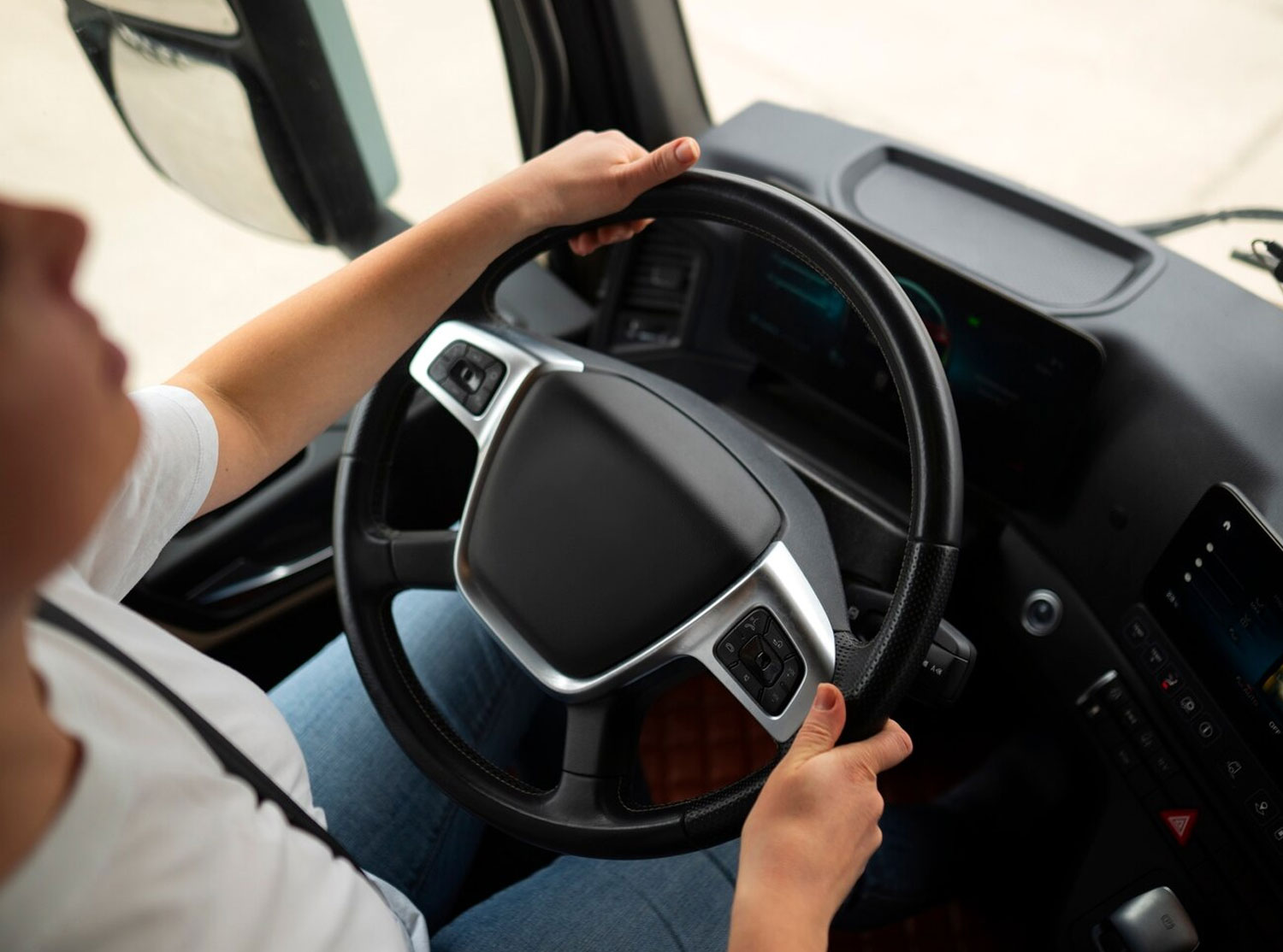Technician inspecting a commercial truck steering system